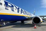 a blue and yellow ryanair plane is parked on the tarmac