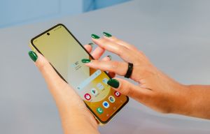 a person with green nails is using a phone that shows the time as 8:51