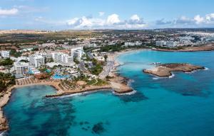 an aerial view of a beach with a city in the background