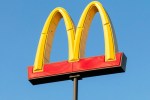 a red and yellow mcdonald 's sign against a blue sky