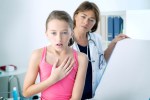 a young girl is being examined by a doctor