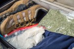 a bag of dried herbs sits next to a pair of shoes