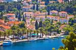 a small town with a clock tower and palm trees